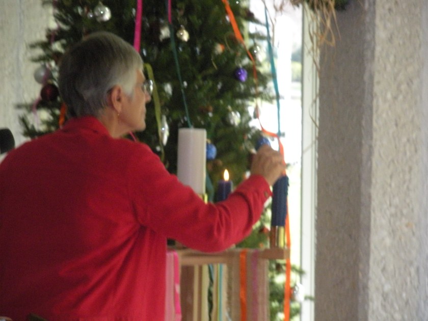 Claire lights the third candle