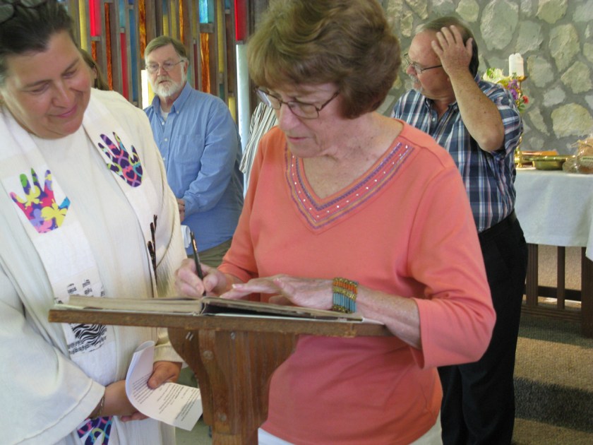 Lucille Ruga signing church registry