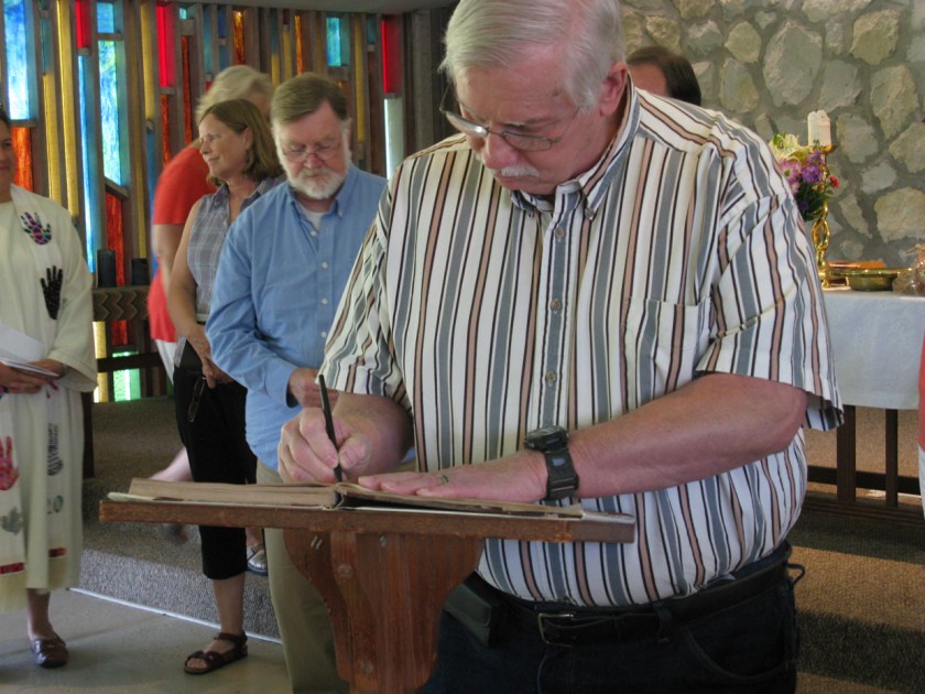 Don Ritchie signing church registry