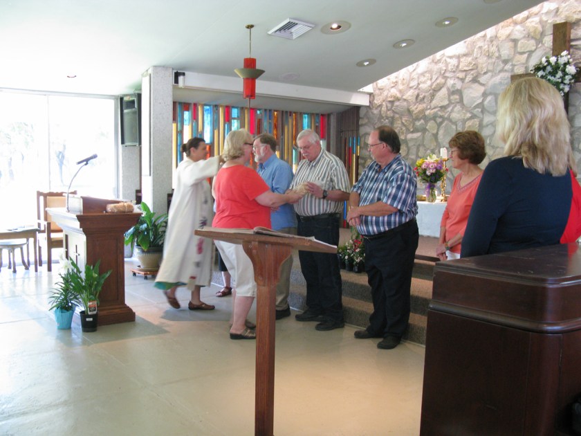 Advisor, Denise Williams, and Rev. Wells give new member, Don Ritchie, a gift of newly baked bread and extend the right hand of friendship